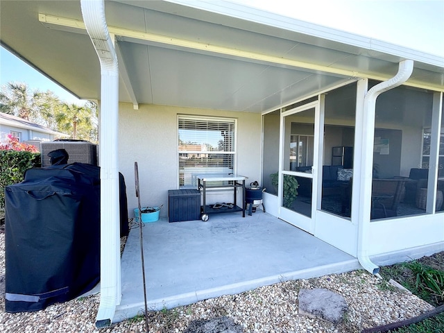 view of patio / terrace featuring a grill and a sunroom