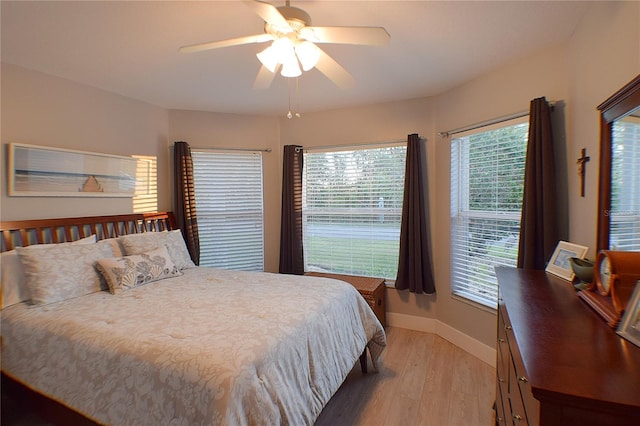 bedroom with ceiling fan and light hardwood / wood-style floors