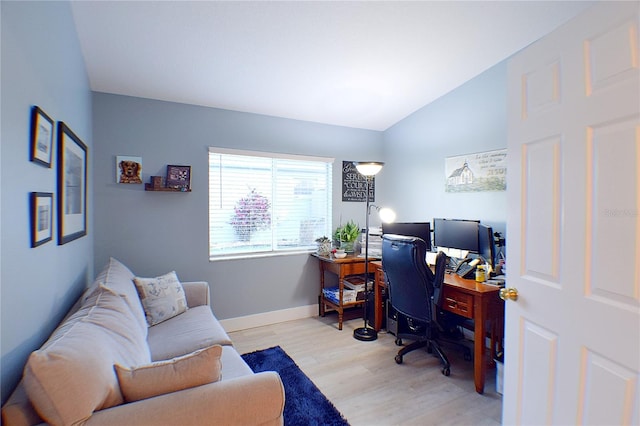 office area featuring vaulted ceiling and light hardwood / wood-style flooring