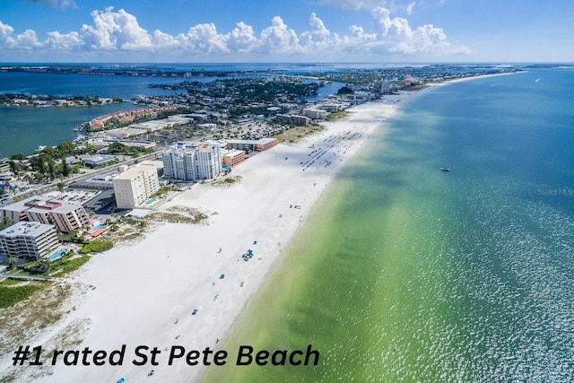 drone / aerial view with a beach view and a water view