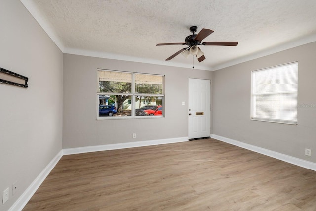 unfurnished room with ceiling fan, hardwood / wood-style flooring, and a textured ceiling