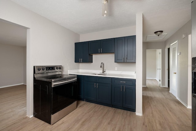 kitchen with sink, light hardwood / wood-style flooring, a textured ceiling, and electric stove