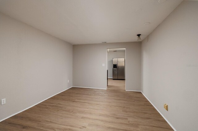 spare room with light hardwood / wood-style flooring