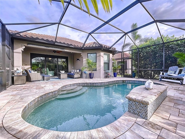 view of swimming pool with a lanai, an outdoor hangout area, ceiling fan, and a patio area