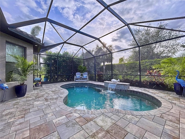 view of swimming pool featuring pool water feature, glass enclosure, and a patio