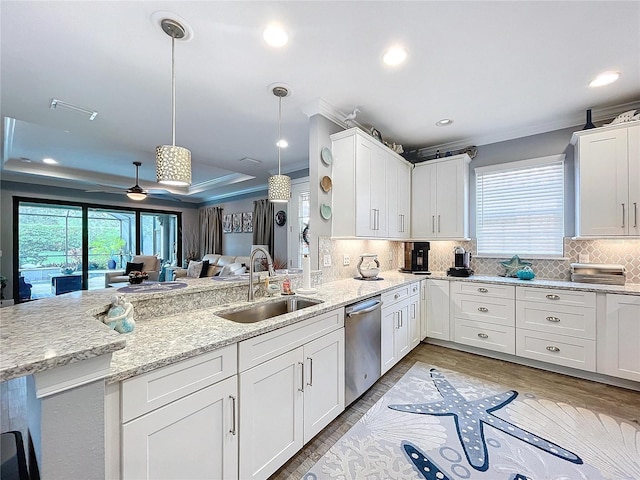 kitchen with stainless steel dishwasher, ceiling fan, sink, white cabinets, and hanging light fixtures