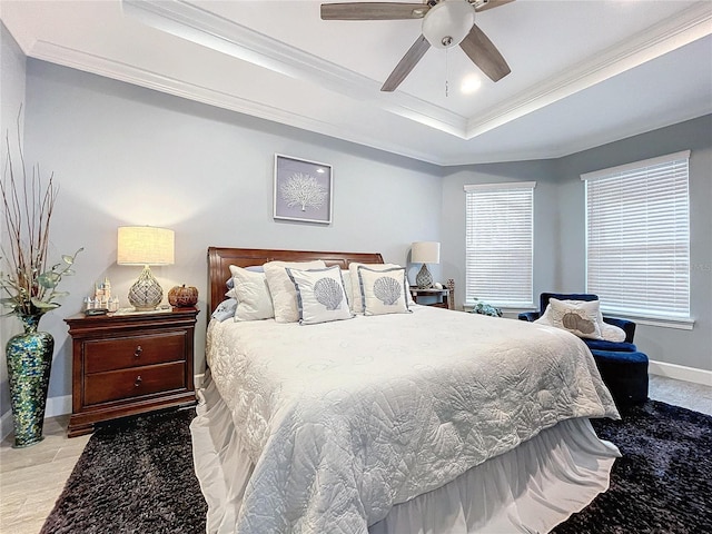 bedroom featuring ceiling fan, light hardwood / wood-style floors, crown molding, and a tray ceiling