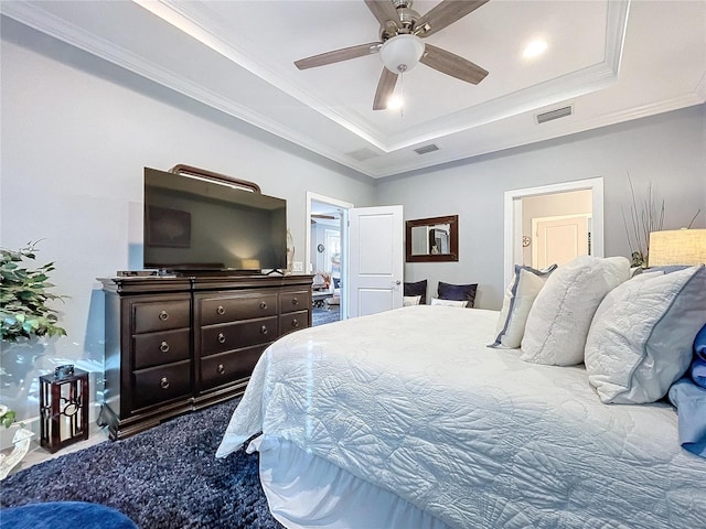 bedroom with a raised ceiling, ceiling fan, and crown molding