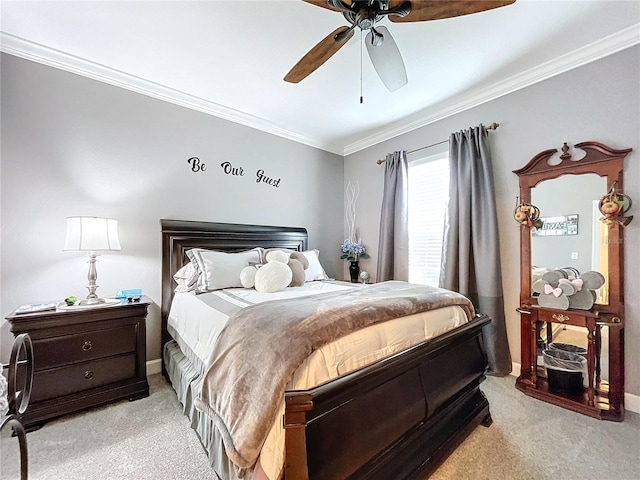 carpeted bedroom featuring ceiling fan and crown molding