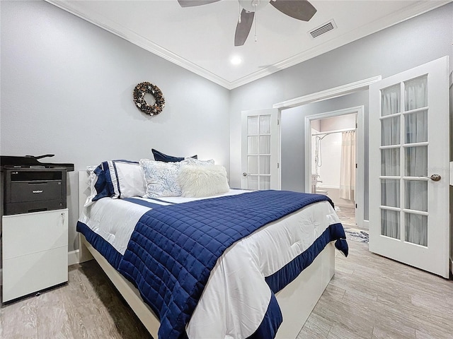 bedroom with ceiling fan, french doors, ensuite bathroom, hardwood / wood-style floors, and ornamental molding