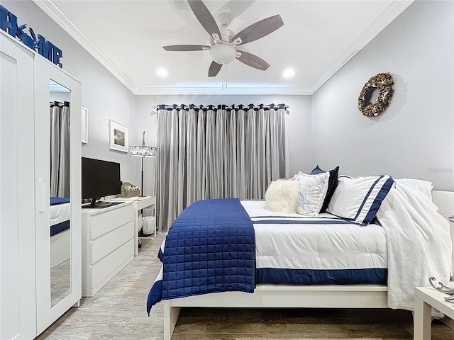 bedroom with light hardwood / wood-style floors, ceiling fan, and crown molding