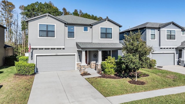 view of front of property featuring a front yard and a garage