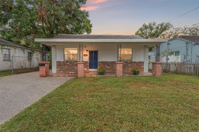 view of front of home with a yard and covered porch