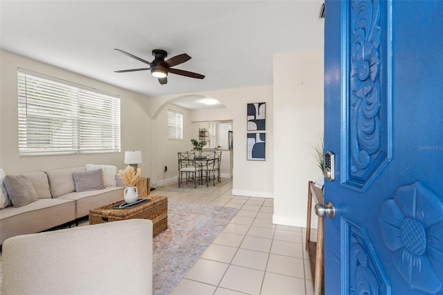 living room with ceiling fan and light tile patterned floors