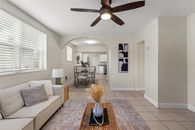 tiled living room featuring ceiling fan