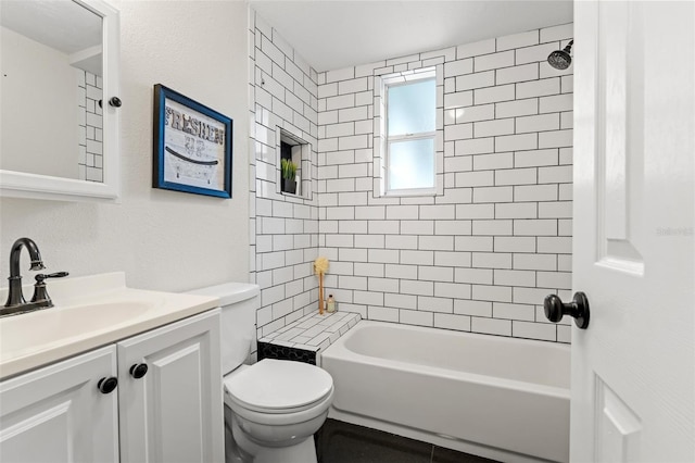 full bathroom featuring vanity, toilet, and tiled shower / bath