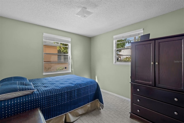 carpeted bedroom featuring a textured ceiling