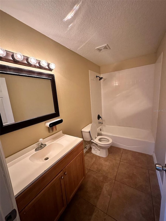 full bathroom with tile patterned floors, vanity, a textured ceiling,  shower combination, and toilet