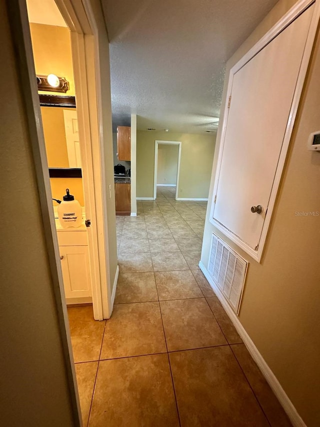 hallway featuring light tile patterned floors