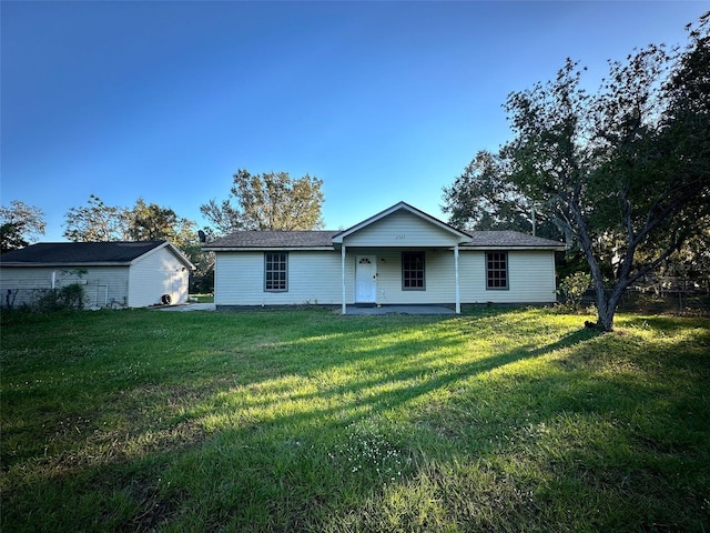 back of property featuring a lawn