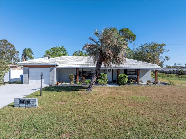 view of front of house with a front yard and a garage