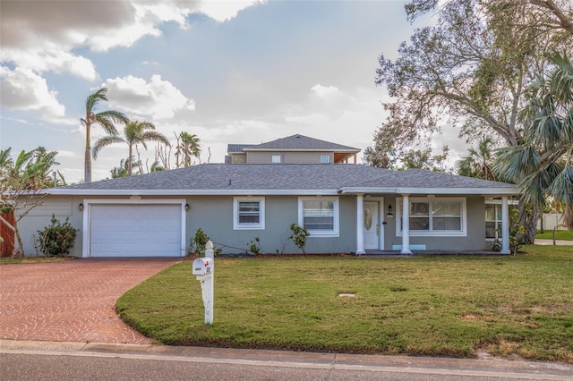 view of front of property with a front yard and a garage