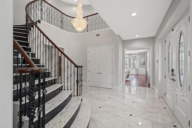 foyer entrance featuring an inviting chandelier