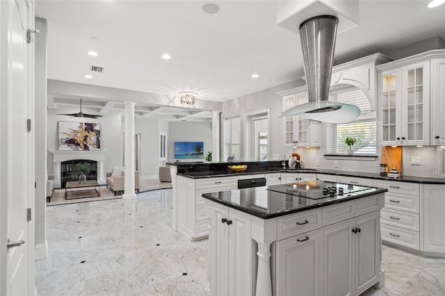 kitchen featuring white cabinets, black electric stovetop, a kitchen island, and sink