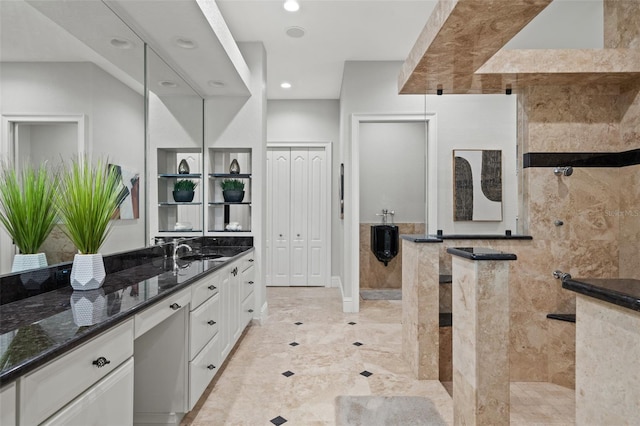 bathroom featuring vanity and tiled shower