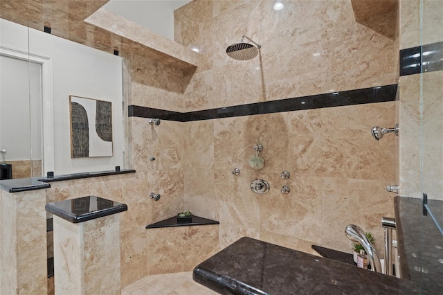 bathroom with a tile shower and tile walls