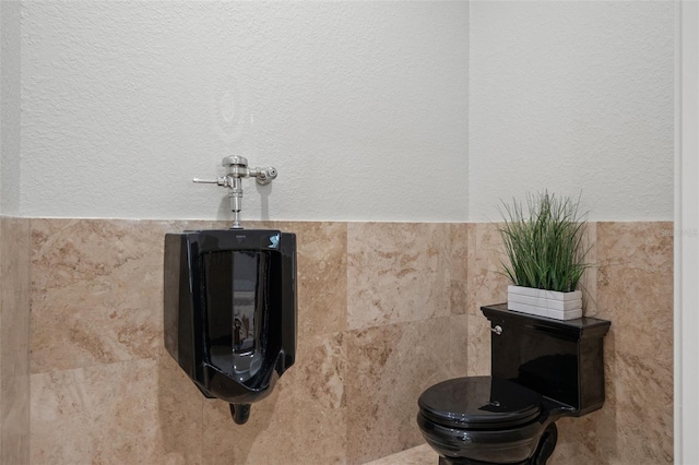 bathroom with tile walls