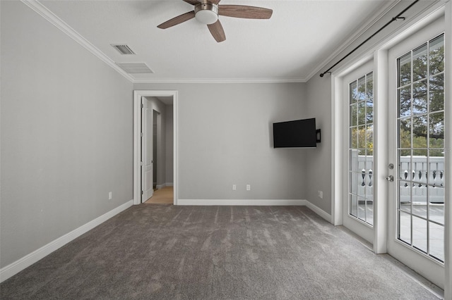 spare room with carpet flooring, crown molding, and ceiling fan