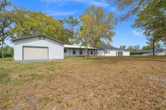 single story home with a garage and a front lawn