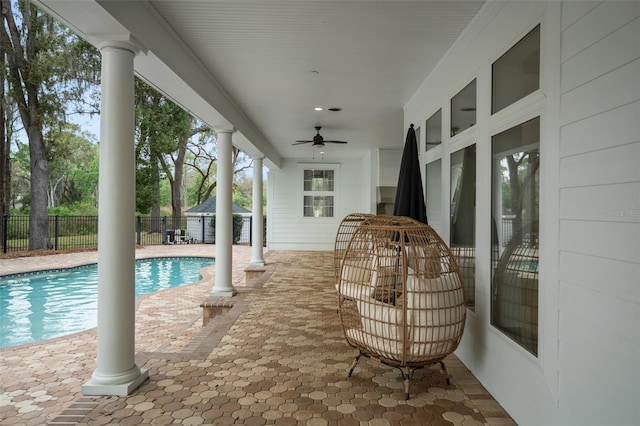 view of patio featuring a fenced in pool and ceiling fan