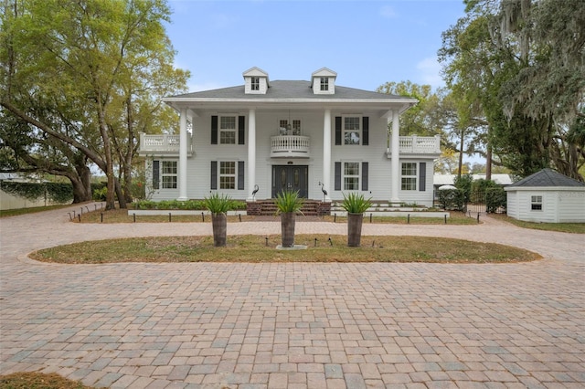 greek revival inspired property with an outbuilding and a balcony