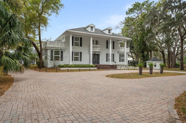 greek revival house featuring a balcony