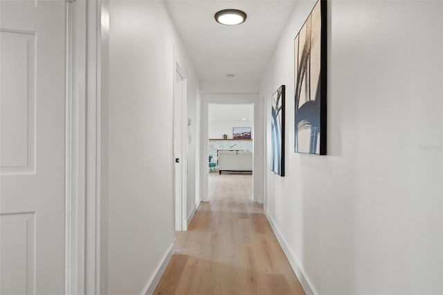 hallway with light hardwood / wood-style flooring