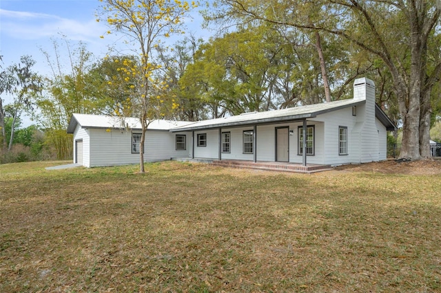 single story home featuring covered porch and a front lawn