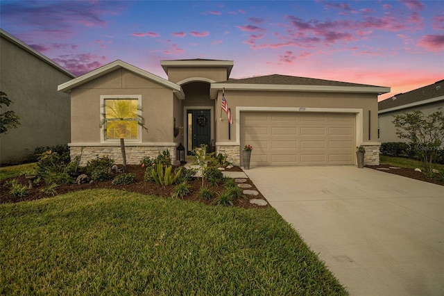 view of front facade with a garage and a yard