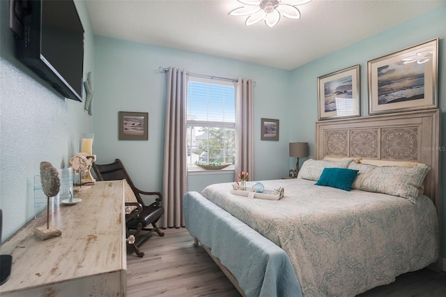 bedroom featuring light hardwood / wood-style flooring and ceiling fan