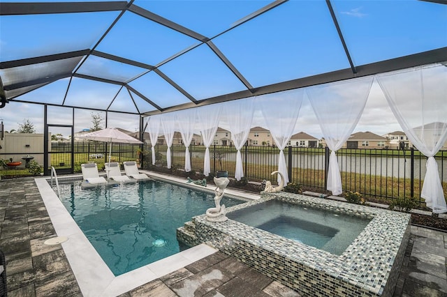 view of pool with an in ground hot tub, a water view, a patio area, and a lanai