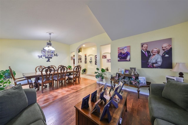 living room with dark hardwood / wood-style flooring and vaulted ceiling