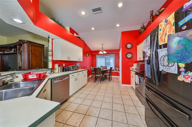 kitchen featuring lofted ceiling, an inviting chandelier, white cabinets, sink, and appliances with stainless steel finishes