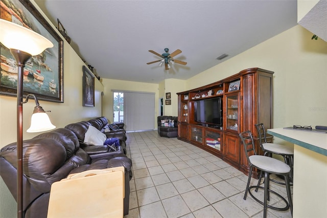 living room with ceiling fan and light tile patterned flooring