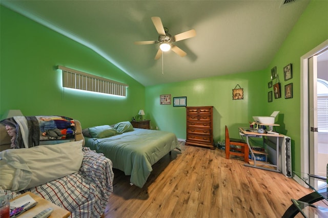 bedroom with light wood-type flooring, ceiling fan, and lofted ceiling