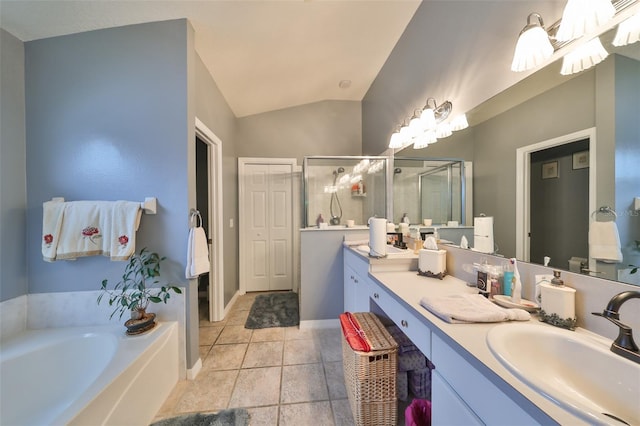 bathroom featuring vanity, independent shower and bath, and vaulted ceiling