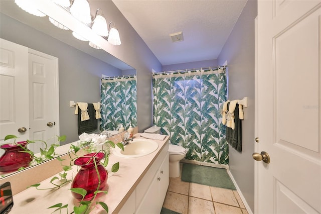 bathroom with vanity, tile patterned floors, a shower with shower curtain, toilet, and a textured ceiling