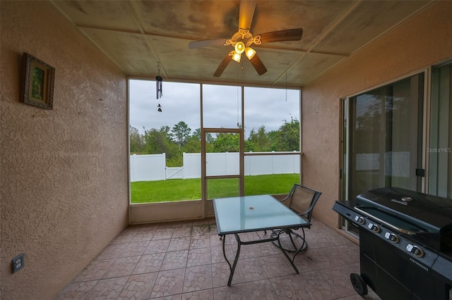 sunroom / solarium featuring ceiling fan