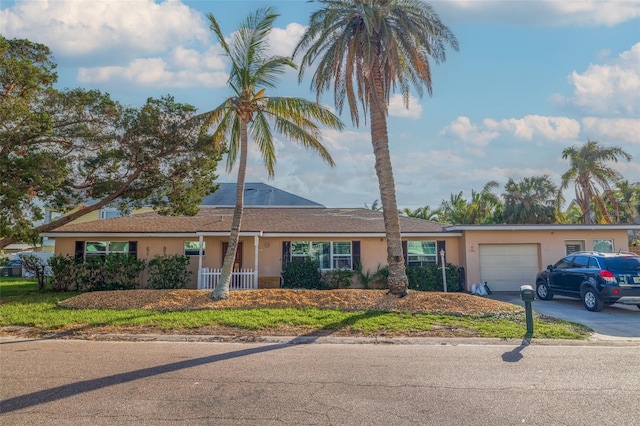 ranch-style house with a front lawn and a garage