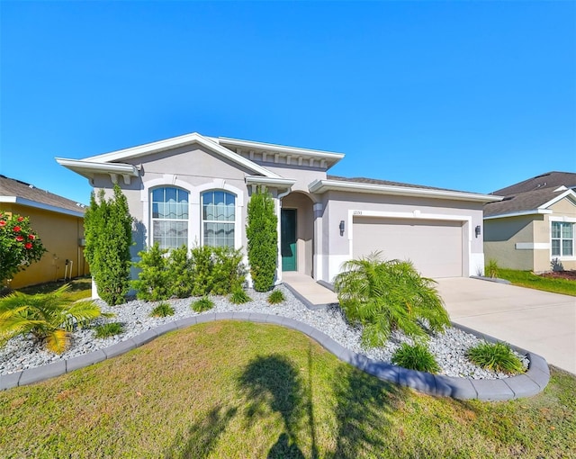 view of front facade featuring an attached garage, a front lawn, concrete driveway, and stucco siding